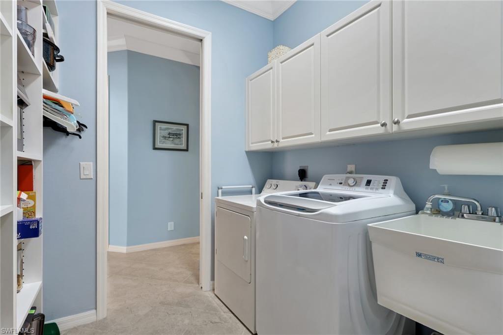 9348 Sun River Way Estero, FL 33928 - Photo 36 of 50 Laundry room featuring cabinet space, independent washer and dryer, and crown molding