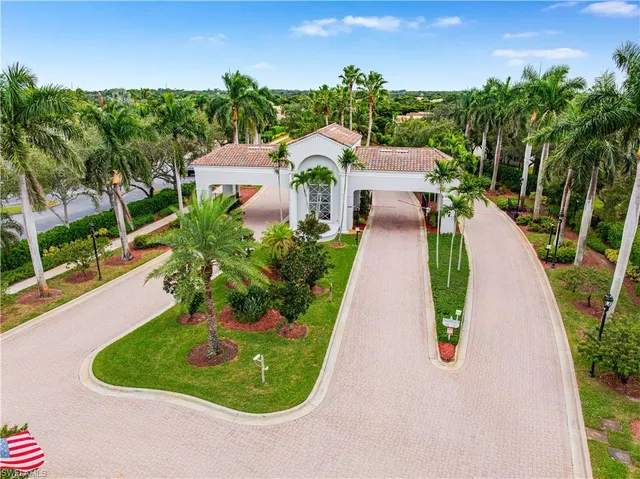 an aerial view of a house with a garden and lake view