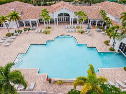 an aerial view of a house with swimming pool and porch