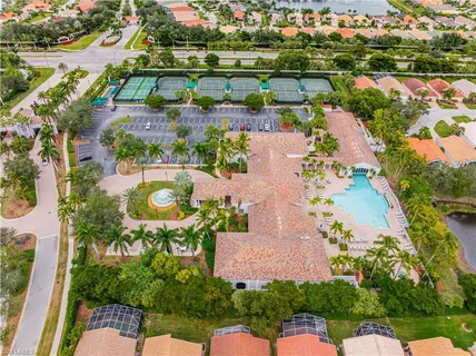 an aerial view of lake residential houses with outdoor space and swimming pool