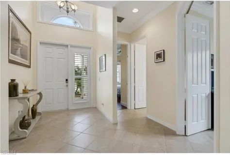 a view of a hallway with workspace and a window