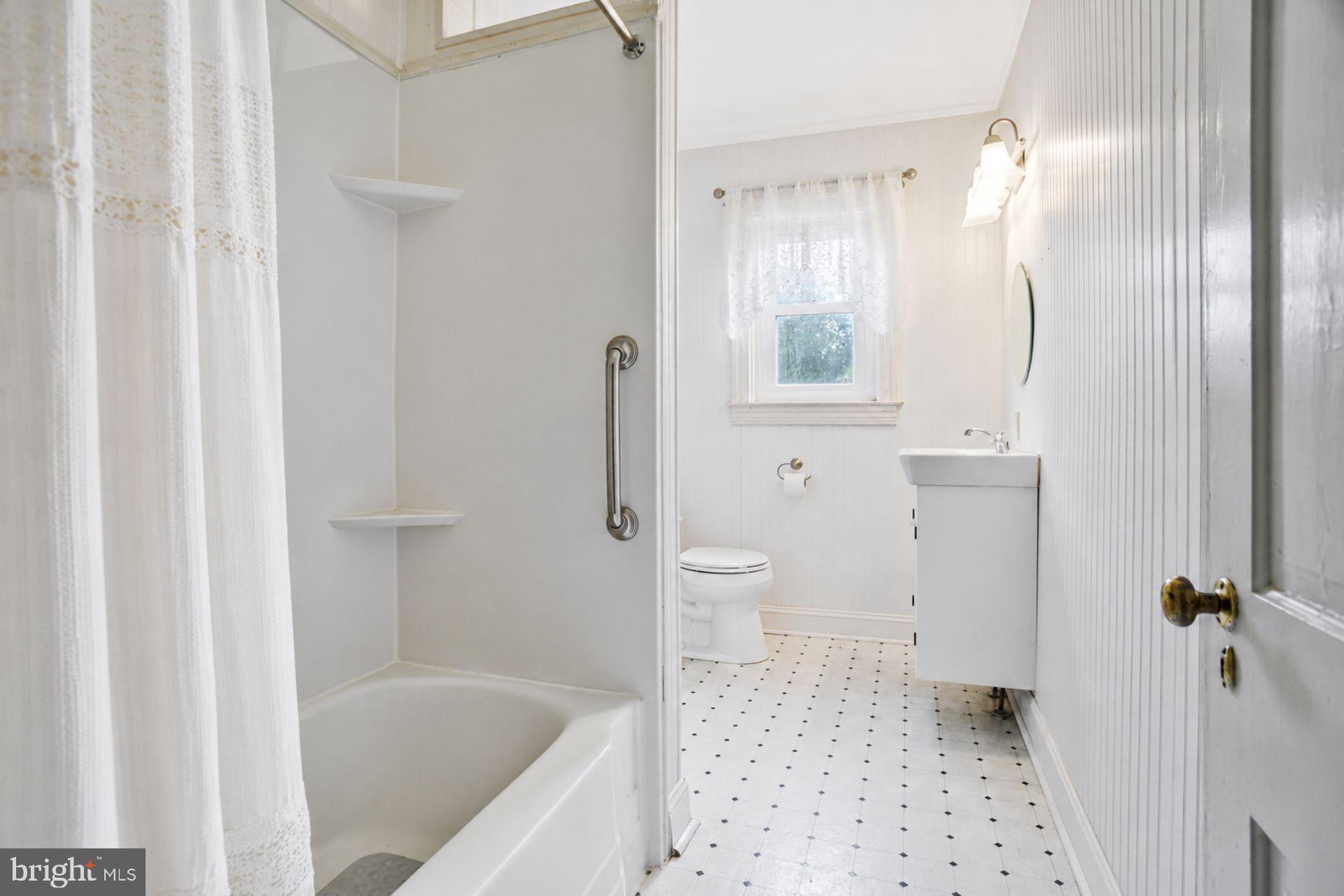 8965 Poorhouse Road Port Tobacco, MD 20677 - Photo 9 of 18 a bathroom with a sink a toilet and shower