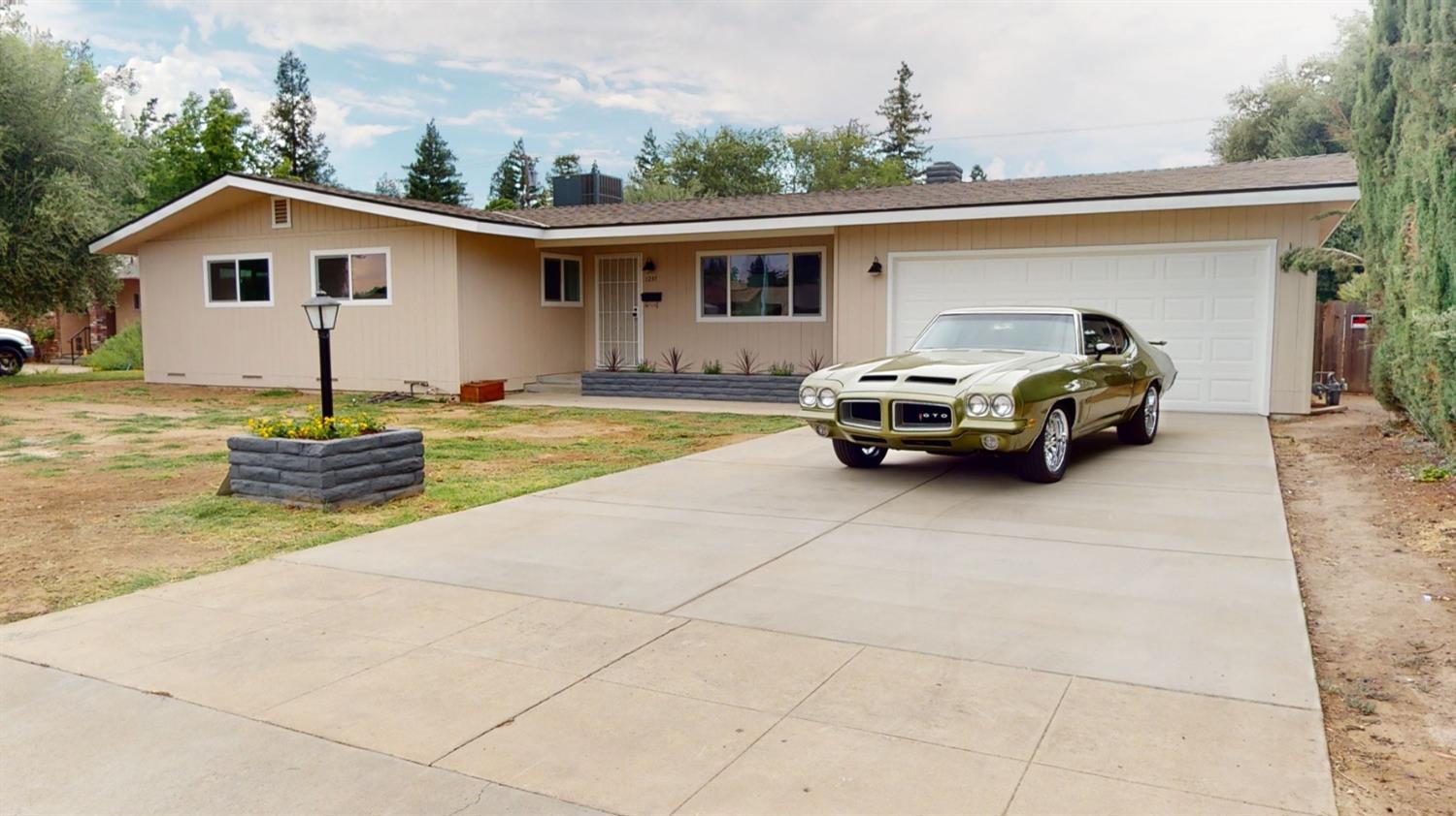 1237 De Cesari Avenue Madera, CA 93637 - Photo 1 of 24 a car parked in front of house