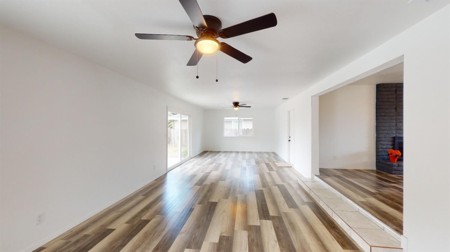 1237 De Cesari Avenue Madera, CA 93637 - Photo 11 of 24 wooden floor in an empty room with a window