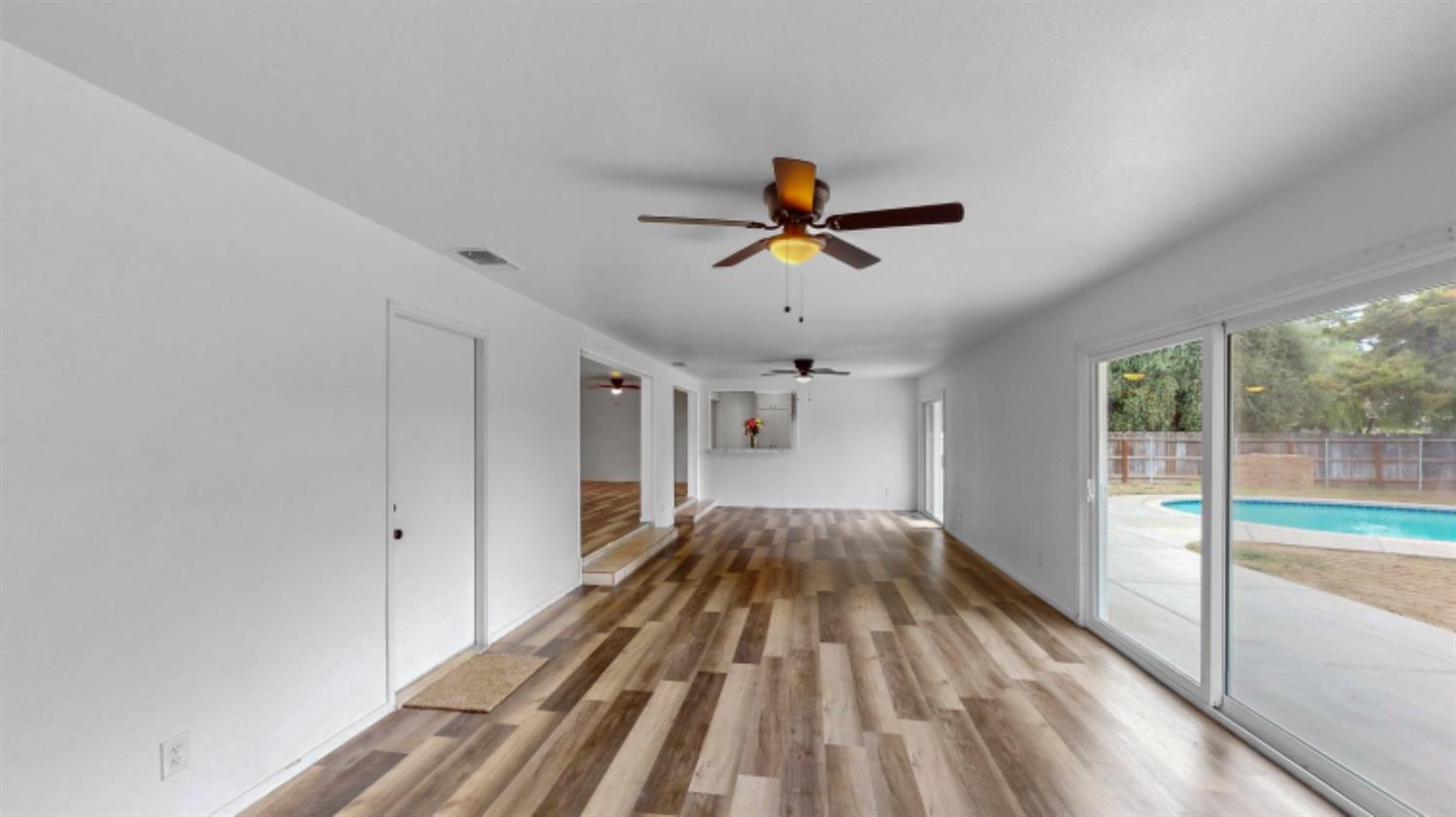 1237 De Cesari Avenue Madera, CA 93637 - Photo 12 of 24 a view of empty room with wooden floor and fan