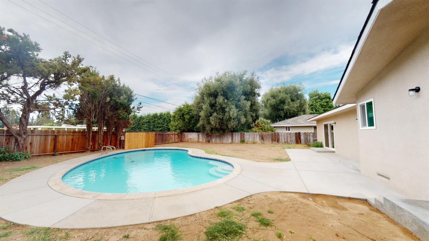 1237 De Cesari Avenue Madera, CA 93637 - Photo 19 of 24 a view of a swimming pool with a patio
