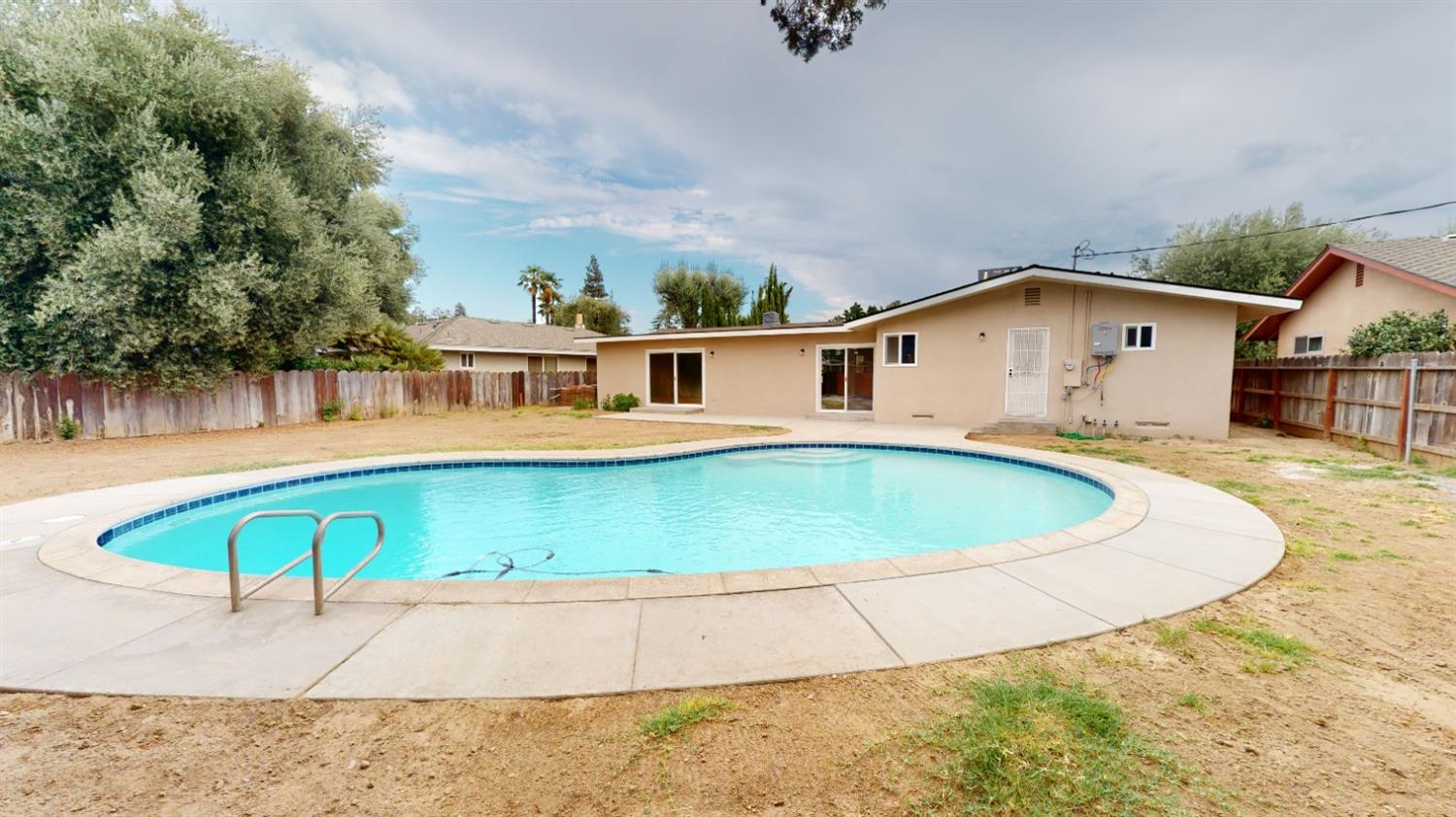 1237 De Cesari Avenue Madera, CA 93637 - Photo 20 of 24 a view of a house with a swimming pool