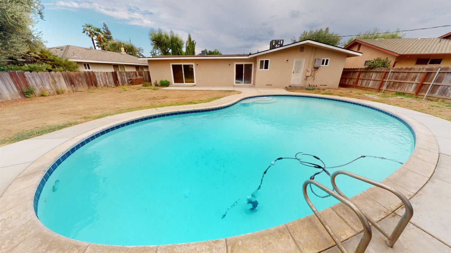 1237 De Cesari Avenue Madera, CA 93637 - Photo 2 of 24 a view of a house with a swimming pool