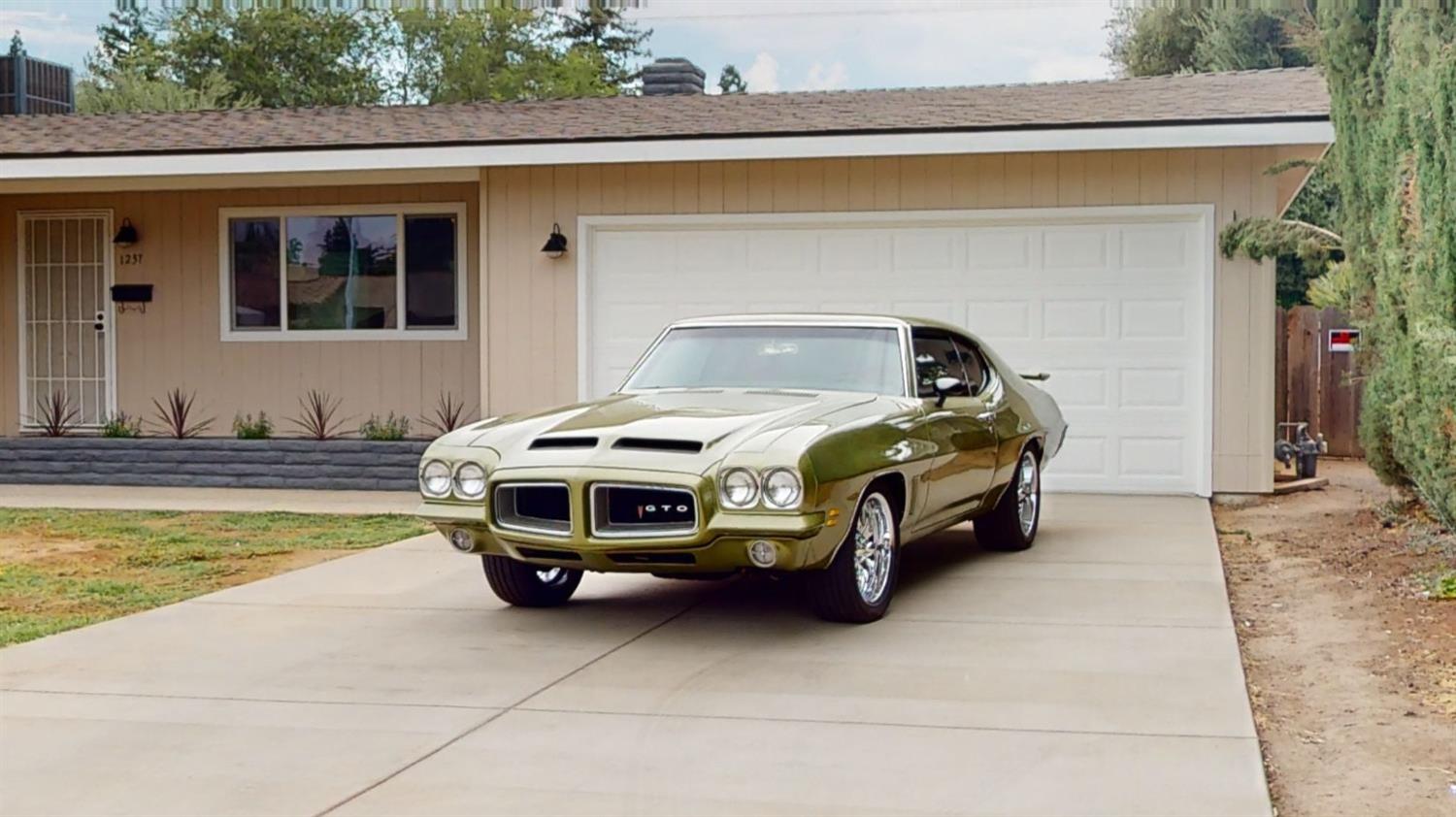1237 De Cesari Avenue Madera, CA 93637 - Photo 23 of 24 a car parked in front of a house