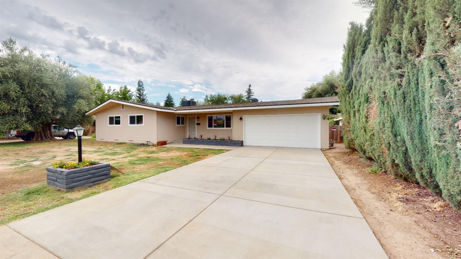 1237 De Cesari Avenue Madera, CA 93637 - Photo 24 of 24 a front view of a house with a yard