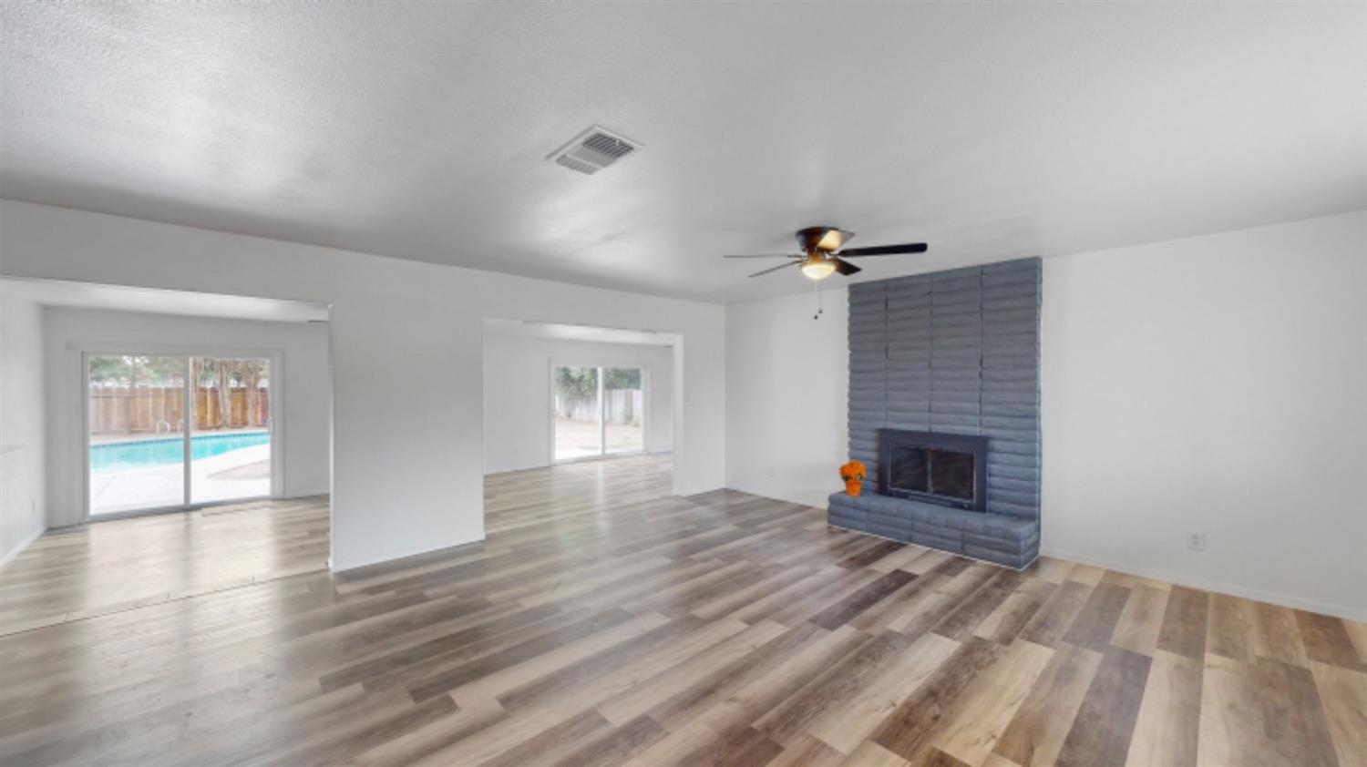 1237 De Cesari Avenue Madera, CA 93637 - Photo 3 of 24 a view of empty room with wooden floor and fireplace