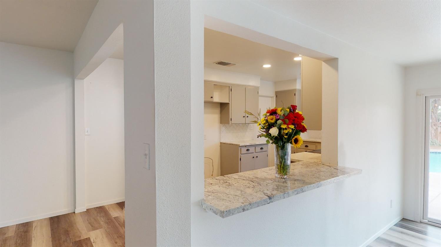 1237 De Cesari Avenue Madera, CA 93637 - Photo 5 of 24 a view of a hallway with a potted plant