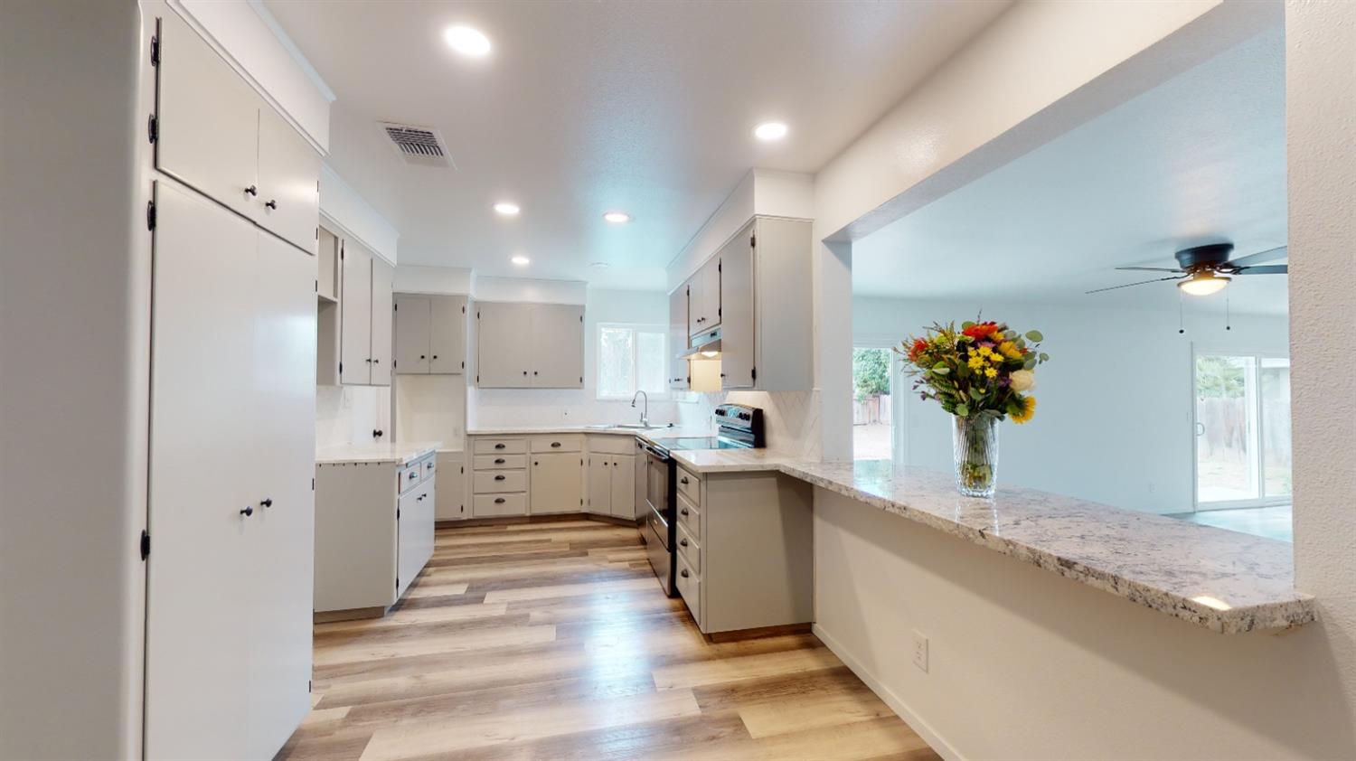 1237 De Cesari Avenue Madera, CA 93637 - Photo 9 of 24 a view of a hallway kitchen and dining room