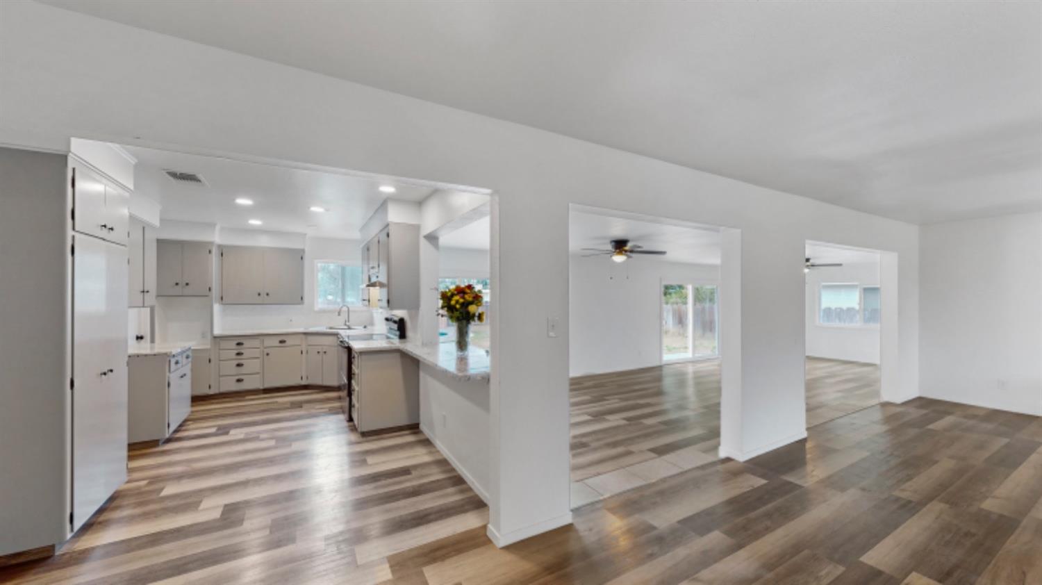 1237 De Cesari Avenue Madera, CA 93637 - Photo 10 of 24 a view of a living room and kitchen with furniture