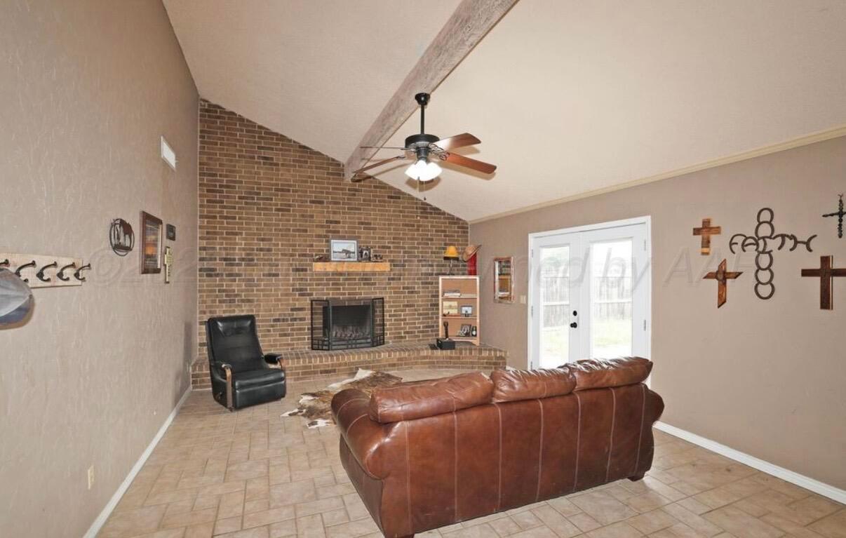 225 Bordeaux Lane Amarillo, TX 79119 - Photo 11 of 25 a living room with furniture and a fireplace