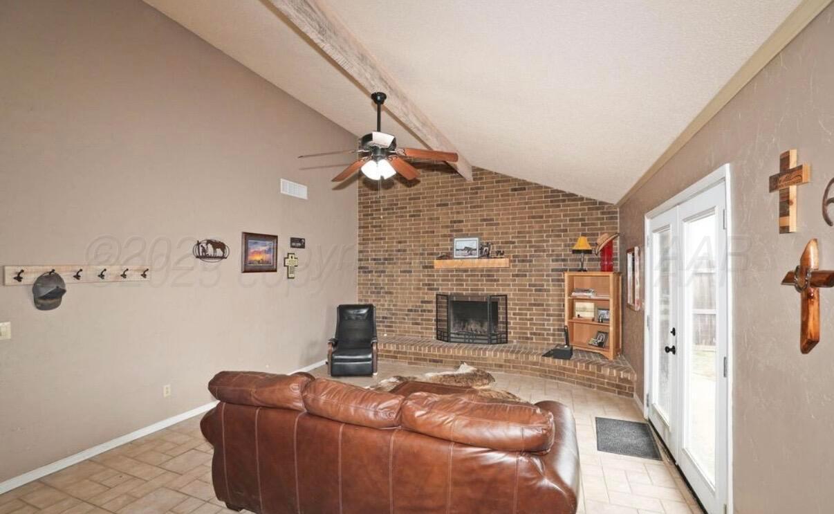 225 Bordeaux Lane Amarillo, TX 79119 - Photo 13 of 25 a living room with furniture and a fireplace