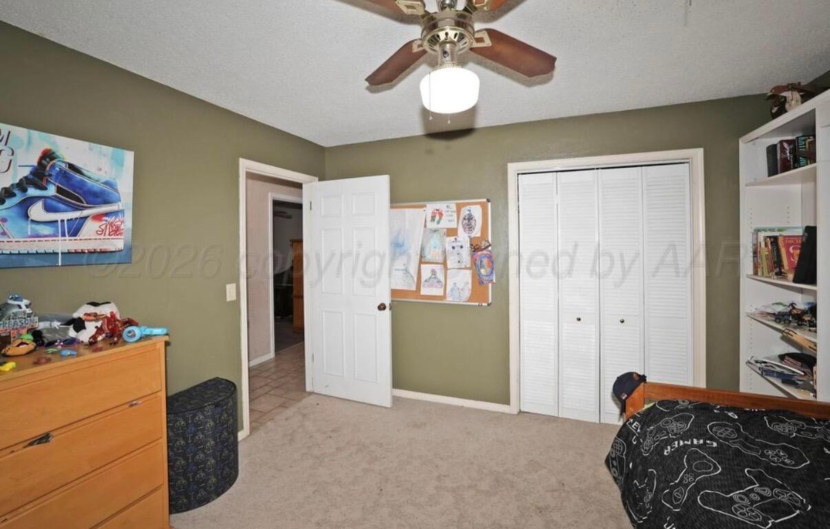 225 Bordeaux Lane Amarillo, TX 79119 - Photo 21 of 25 a bedroom with a bed and cabinets