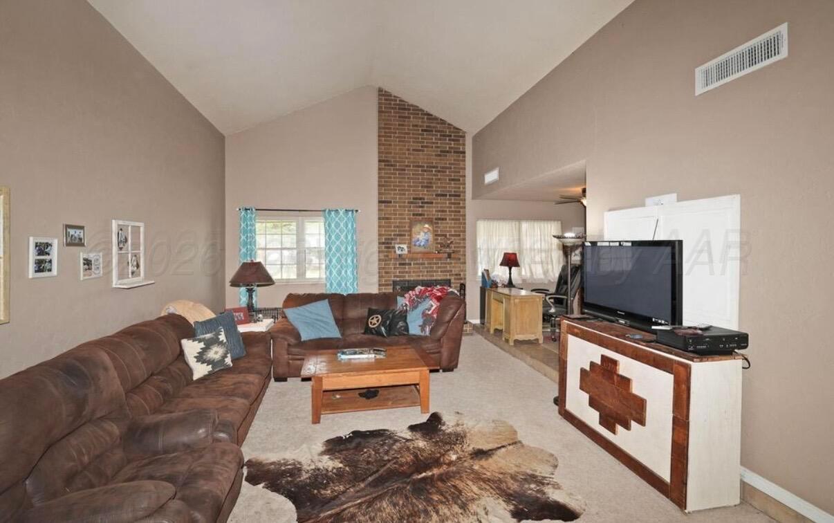 225 Bordeaux Lane Amarillo, TX 79119 - Photo 3 of 25 a living room with furniture and a flat screen tv