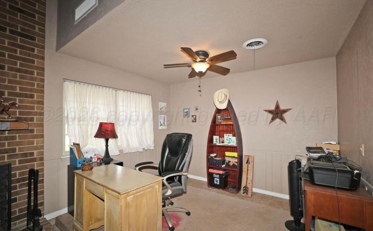 225 Bordeaux Lane Amarillo, TX 79119 - Photo 5 of 25 a view of a workspace with furniture and a window