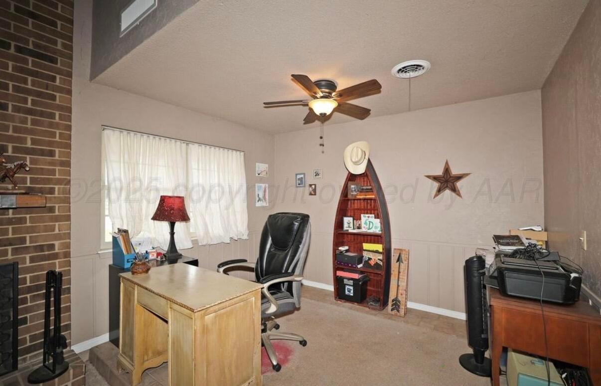 225 Bordeaux Lane Amarillo, TX 79119 - Photo 6 of 25 a view of a workspace with furniture and a window