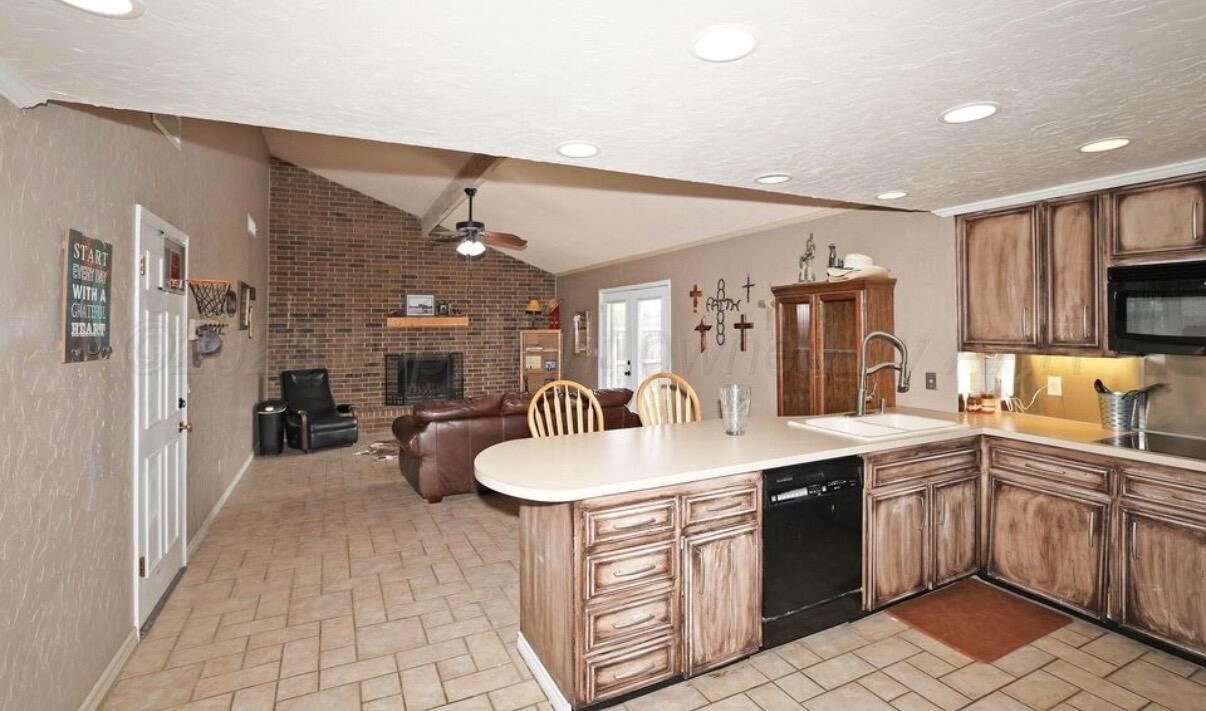 225 Bordeaux Lane Amarillo, TX 79119 - Photo 7 of 25 a kitchen with a sink and cabinets