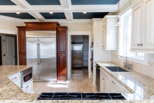 434 Cardon Ridge Drive Smithfield, UT 84335 - Photo 11 of 59 Kitchen with built in appliances, light stone countertops, coffered ceiling, pendant lighting, entrance to large pantry with freezer