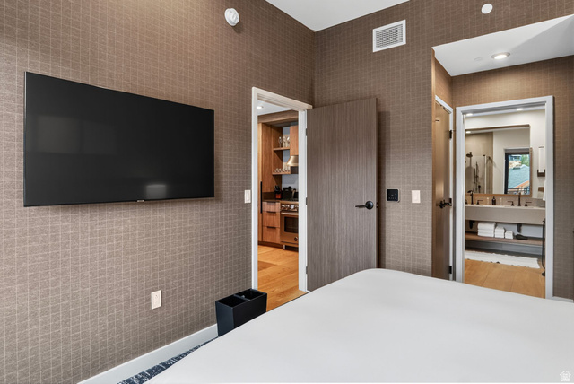 2417 West High Road, Unit 3210 Park City, UT 84098 - Photo 22 of 44 Guest bedroom with a mounted television and direct access to the bath at Pendry Residences Park City.