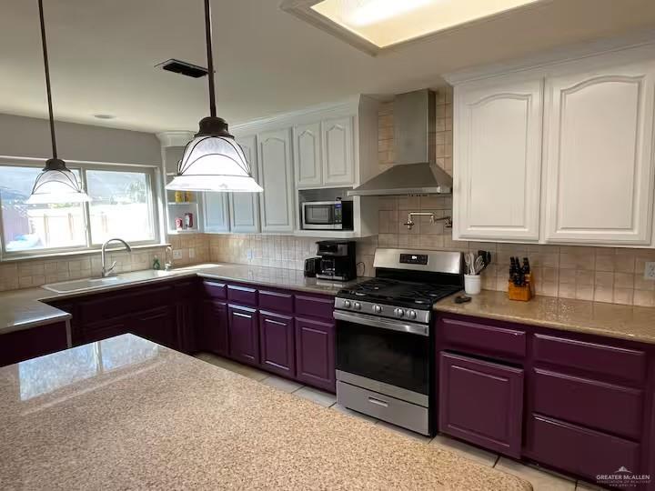 5100 North 16th Street McAllen, TX 78504 - Photo 3 of 14 a kitchen with stainless steel appliances granite countertop a stove a sink and a wooden cabinets