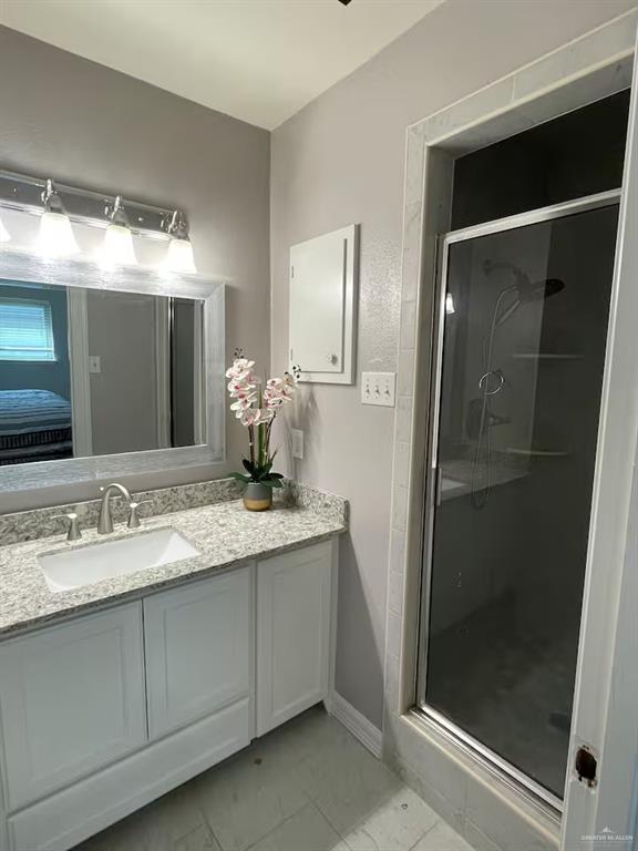 5100 North 16th Street McAllen, TX 78504 - Photo 5 of 14 a bathroom with a granite countertop sink and a mirror