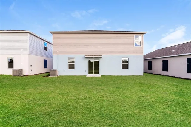 a view of a backyard with plants and a garden