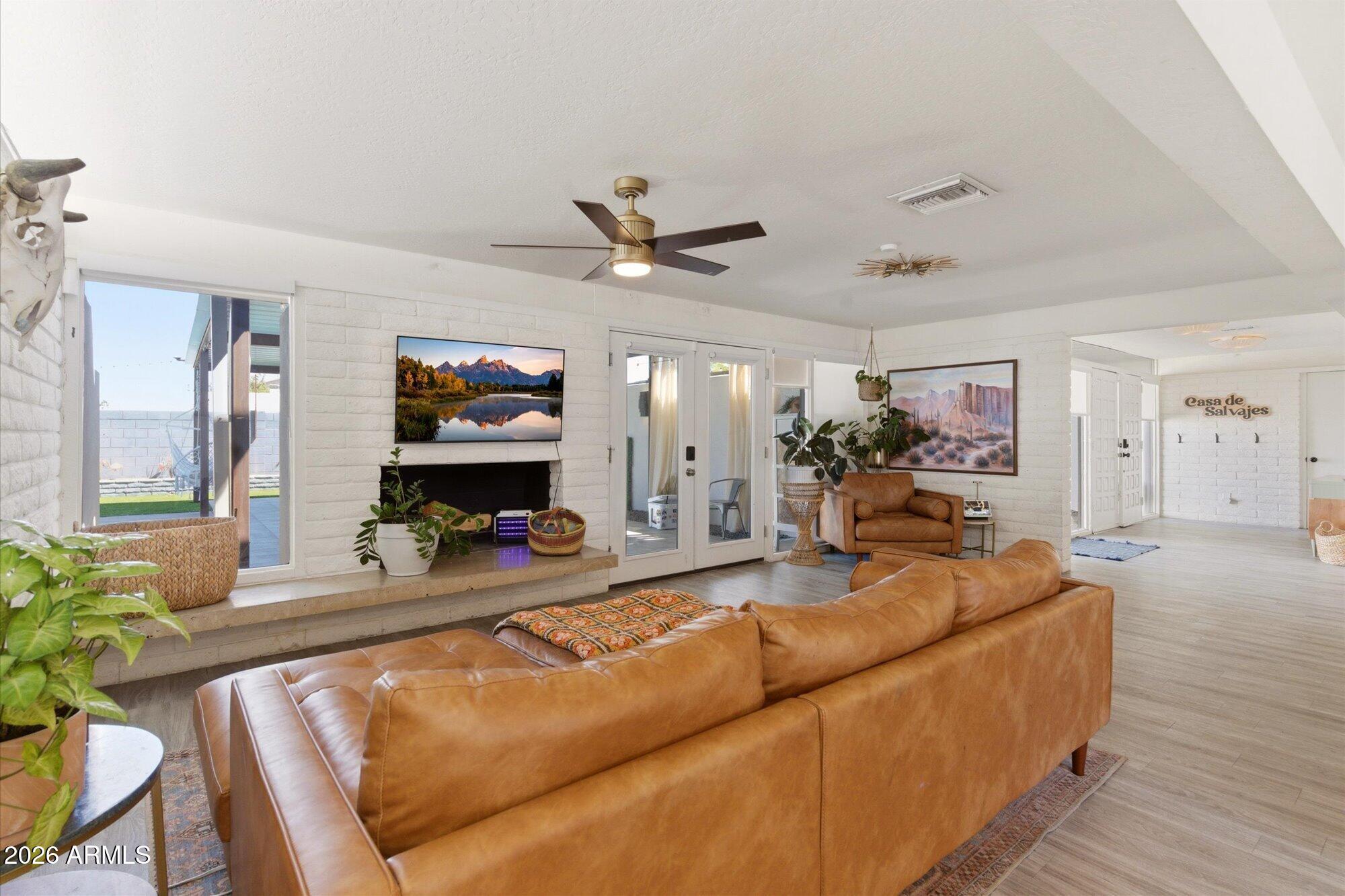 3020 East Wethersfield Road Phoenix, AZ 85032 - Photo 11 of 46 a living room with fireplace furniture and a wooden floor