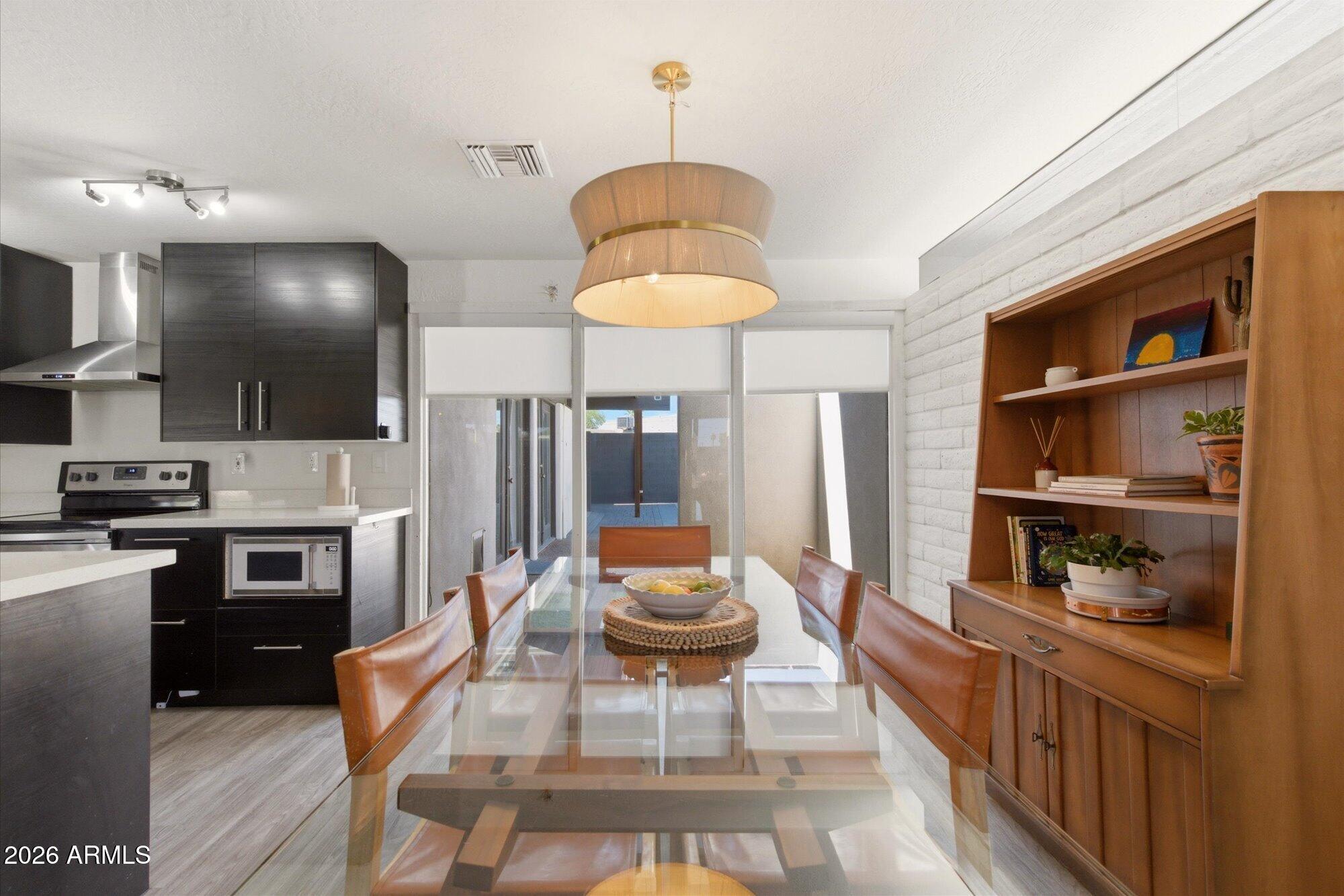 3020 East Wethersfield Road Phoenix, AZ 85032 - Photo 15 of 46 a kitchen with stainless steel appliances granite countertop a stove a sink and a refrigerator