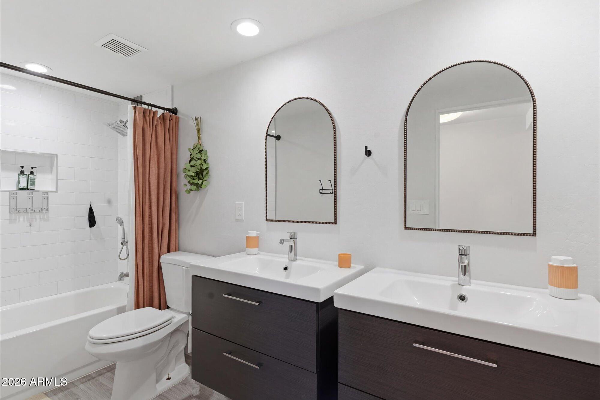 3020 East Wethersfield Road Phoenix, AZ 85032 - Photo 26 of 46 a bathroom with a double vanity sink toilet and shower