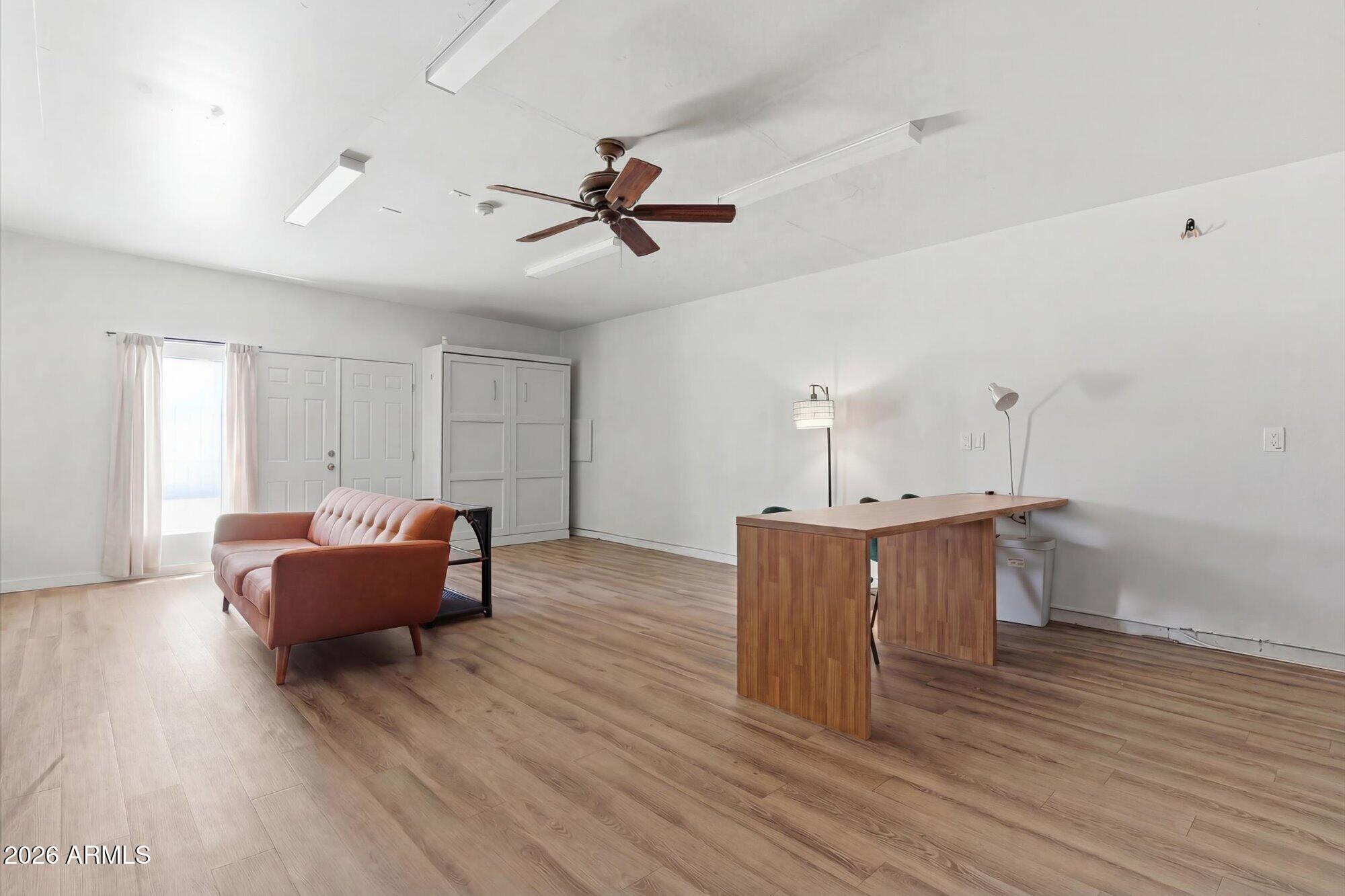 3020 East Wethersfield Road Phoenix, AZ 85032 - Photo 34 of 46 a living room with furniture and a wooden floor