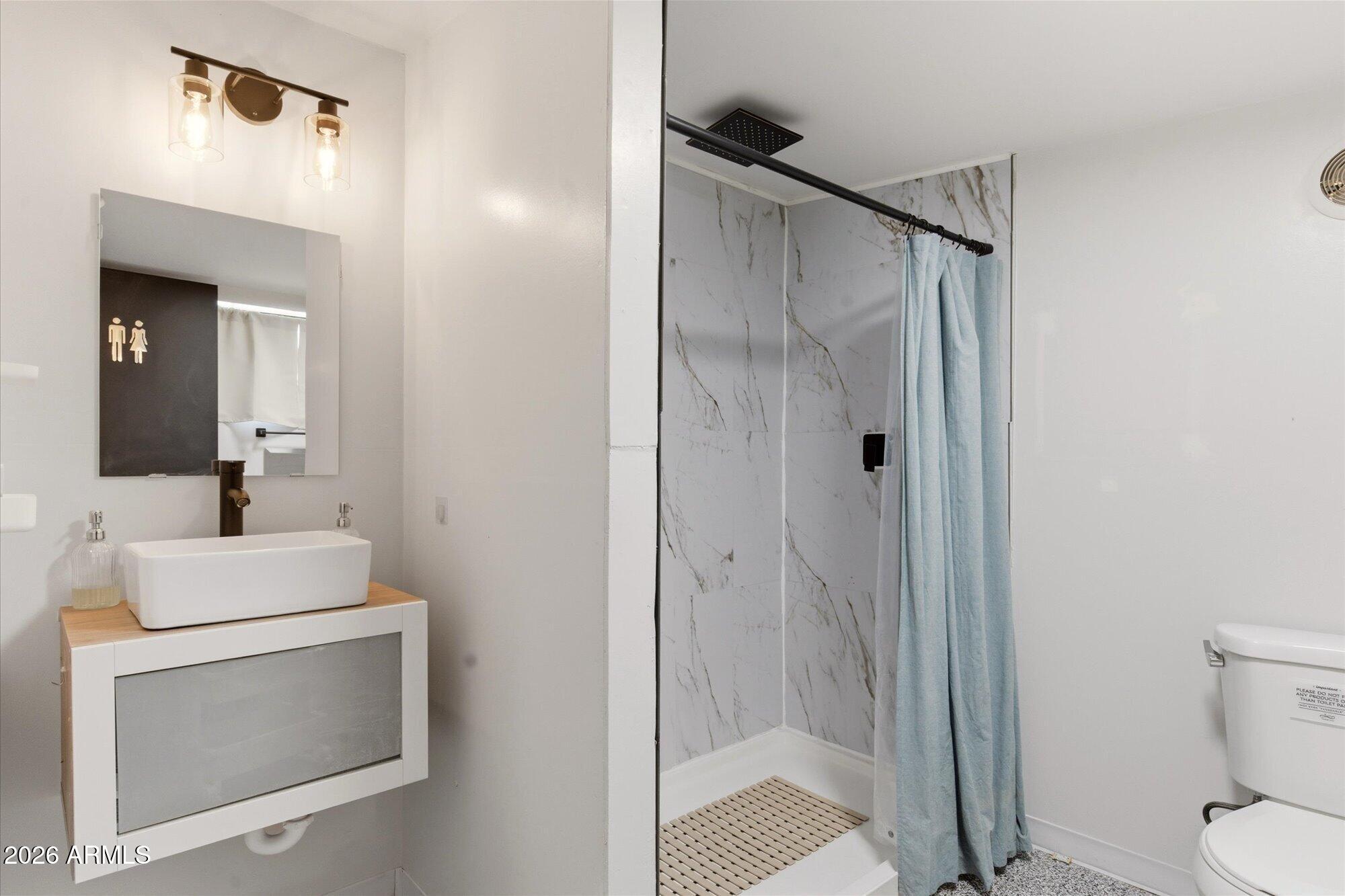 3020 East Wethersfield Road Phoenix, AZ 85032 - Photo 36 of 46 a bathroom with a sink a toilet and shower