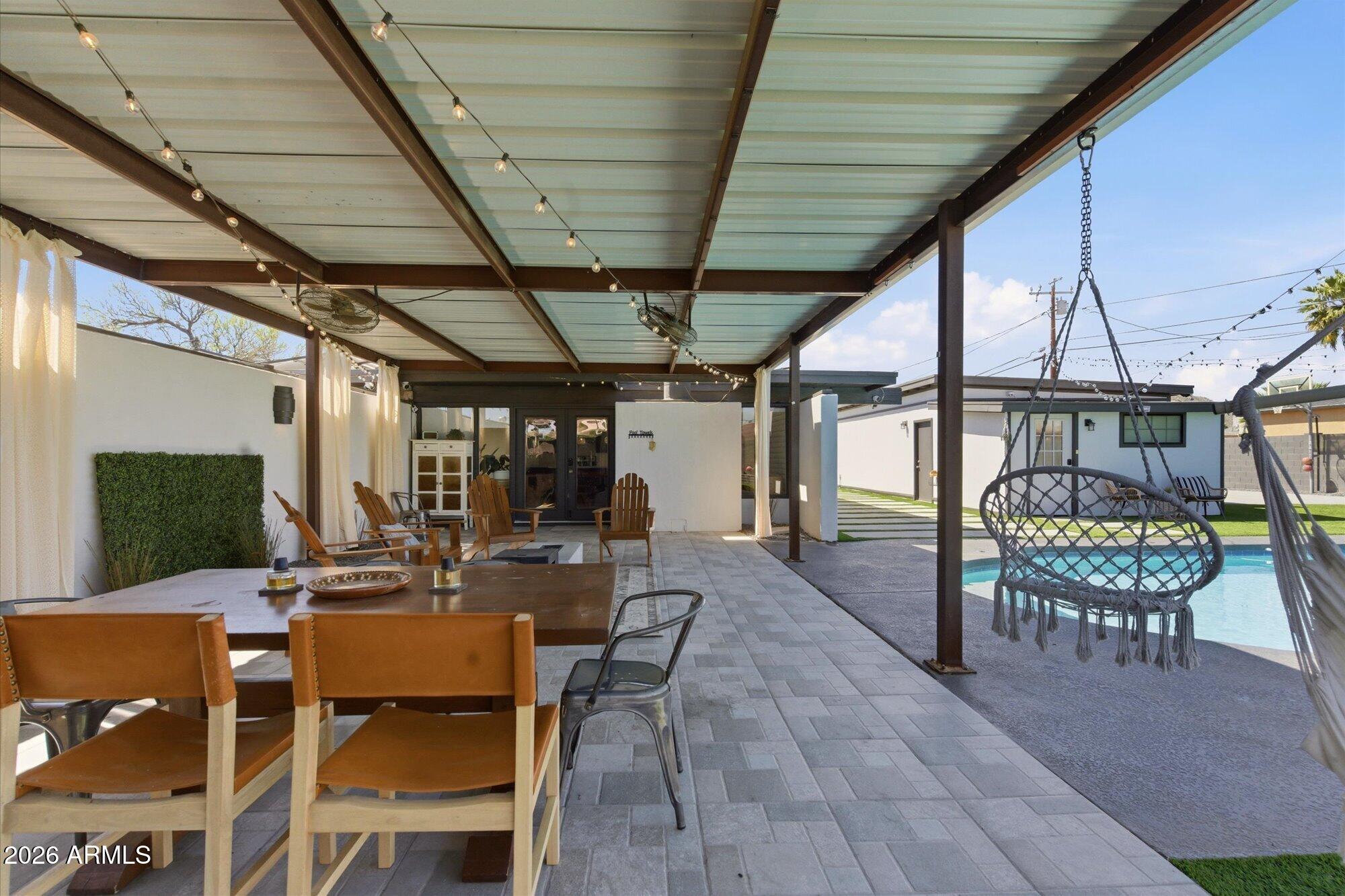 3020 East Wethersfield Road Phoenix, AZ 85032 - Photo 37 of 46 a view of a patio with table and chairs potted plants with wooden floor