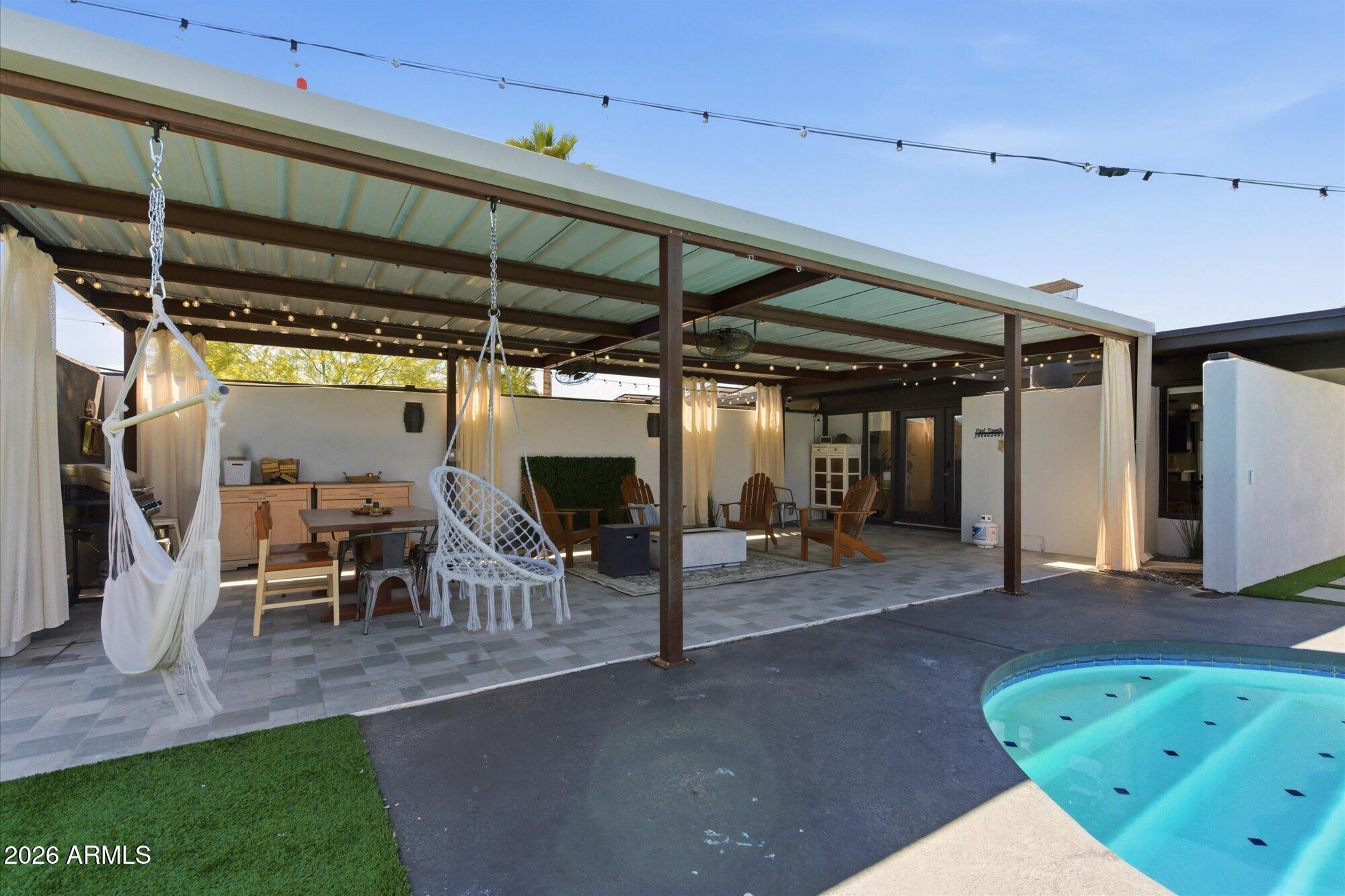 3020 East Wethersfield Road Phoenix, AZ 85032 - Photo 9 of 46 a view of a porch with table and chairs