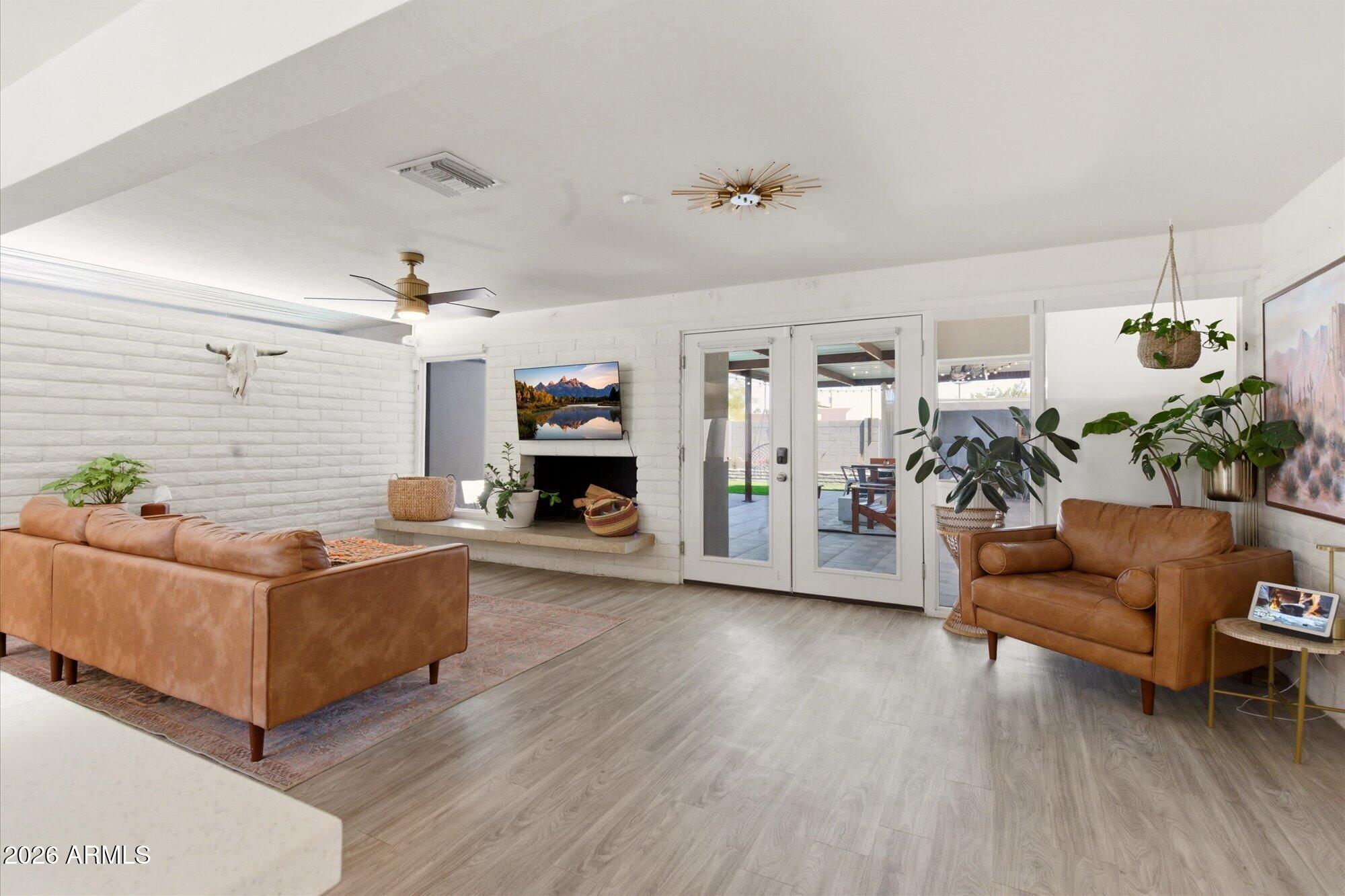 3020 East Wethersfield Road Phoenix, AZ 85032 - Photo 10 of 46 a living room with furniture and a fireplace