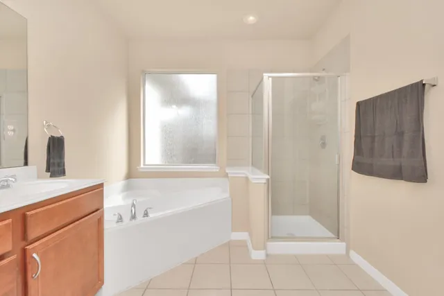 an empty room with a ceiling fan and window