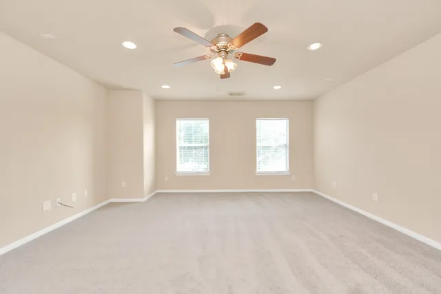 a view of a room with a ceiling fan and a window