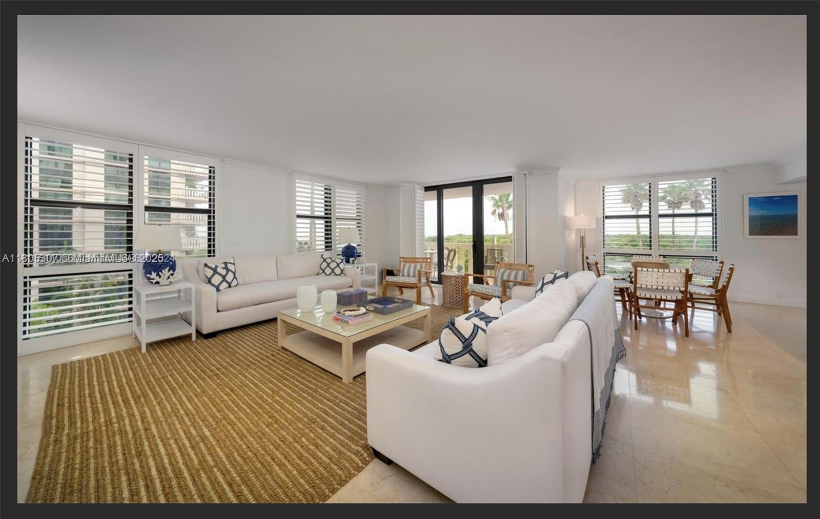 1111 Crandon Boulevard, Unit C406 Key Biscayne, FL 33149 - Photo 2 of 6 a living room with furniture and a large window