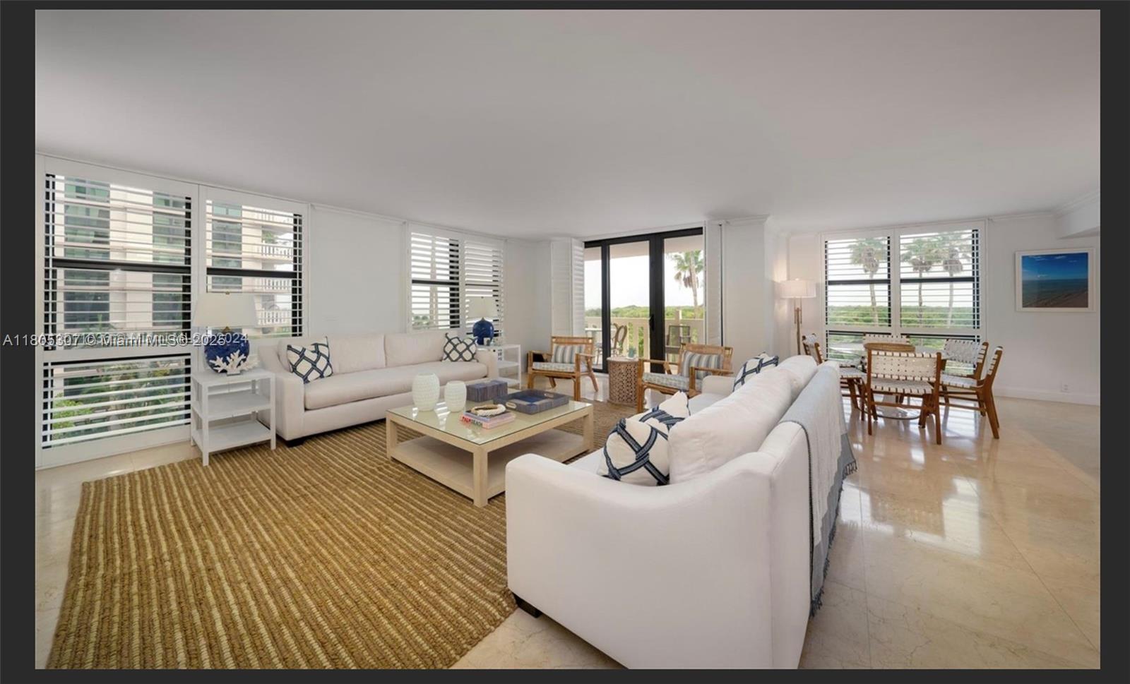 1111 Crandon Boulevard, Unit C406 Key Biscayne, FL 33149 - Photo 4 of 6 a living room with furniture and a large window