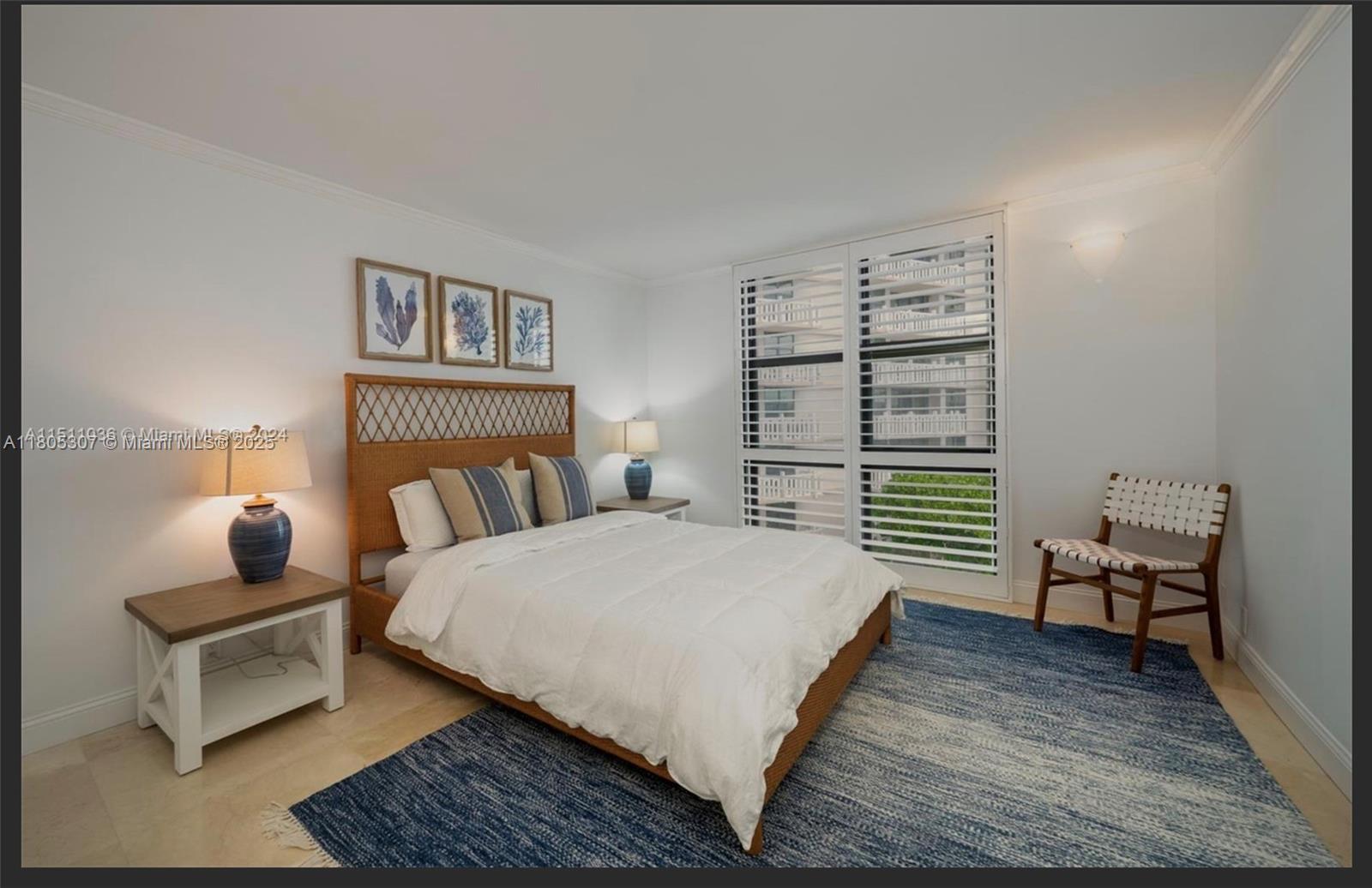 1111 Crandon Boulevard, Unit C406 Key Biscayne, FL 33149 - Photo 5 of 6 a bedroom with a bed wooden floor and lamp