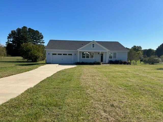 7071 Wheatfield Road Spring Hope, NC 27882 - Photo 1 of 30 a large house with a big yard and large trees