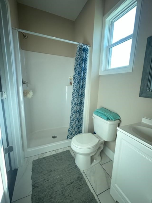 7071 Wheatfield Road Spring Hope, NC 27882 - Photo 14 of 30 a bathroom with a toilet a window and shower