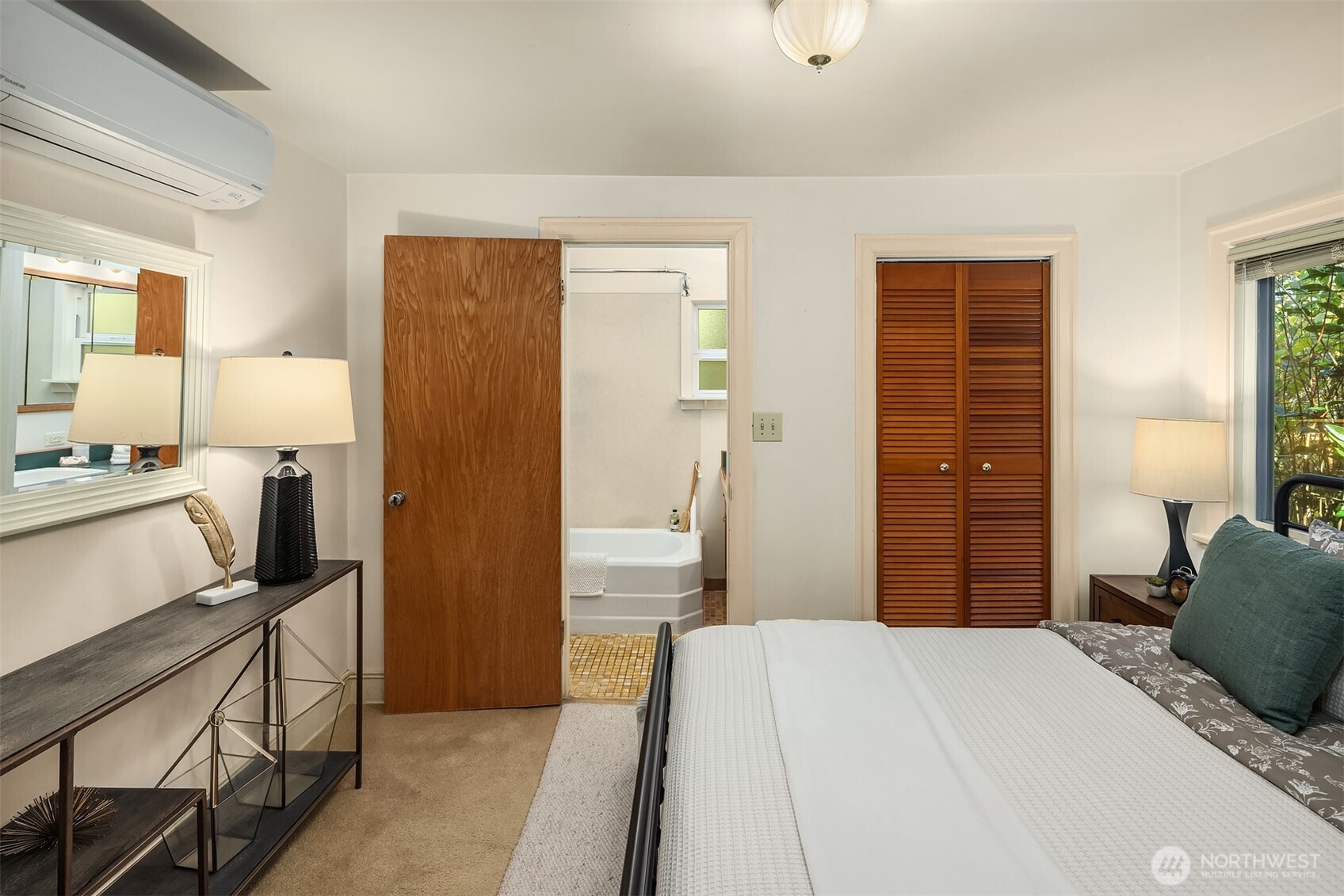 548 Northeast 102nd Street Seattle, WA 98125 - Photo 19 of 27 a bedroom with a bed and a dresser in it