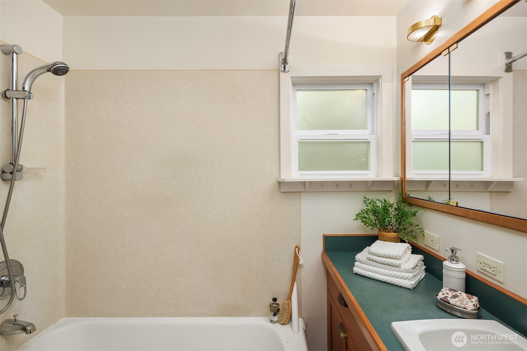548 Northeast 102nd Street Seattle, WA 98125 - Photo 23 of 27 a bathroom with a sink a bathtub and next to a window