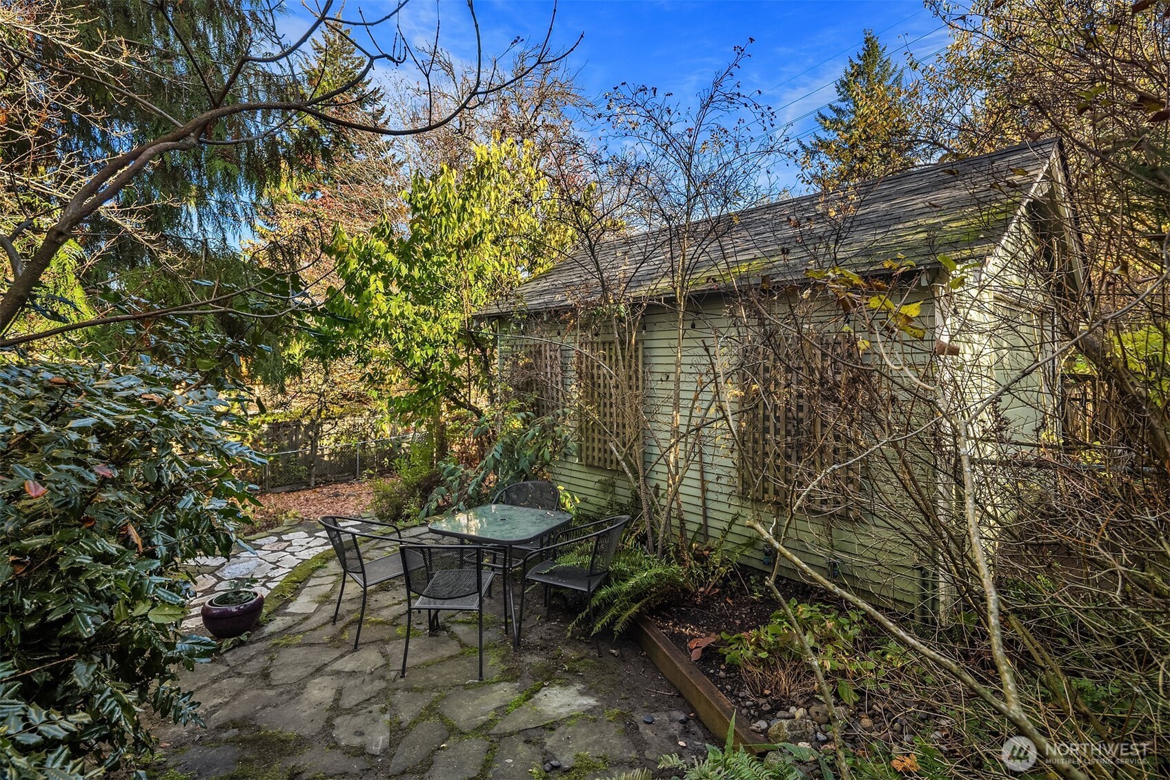 548 Northeast 102nd Street Seattle, WA 98125 - Photo 5 of 27 a backyard of a house with table and chairs