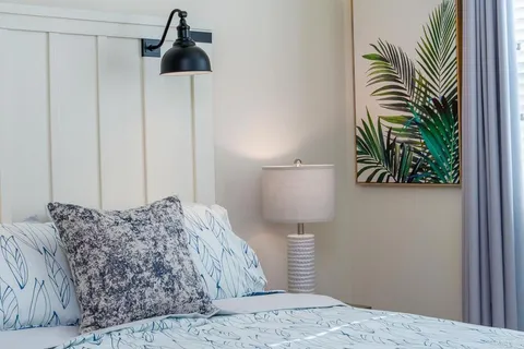 a bedroom with a bed and a lamp on table