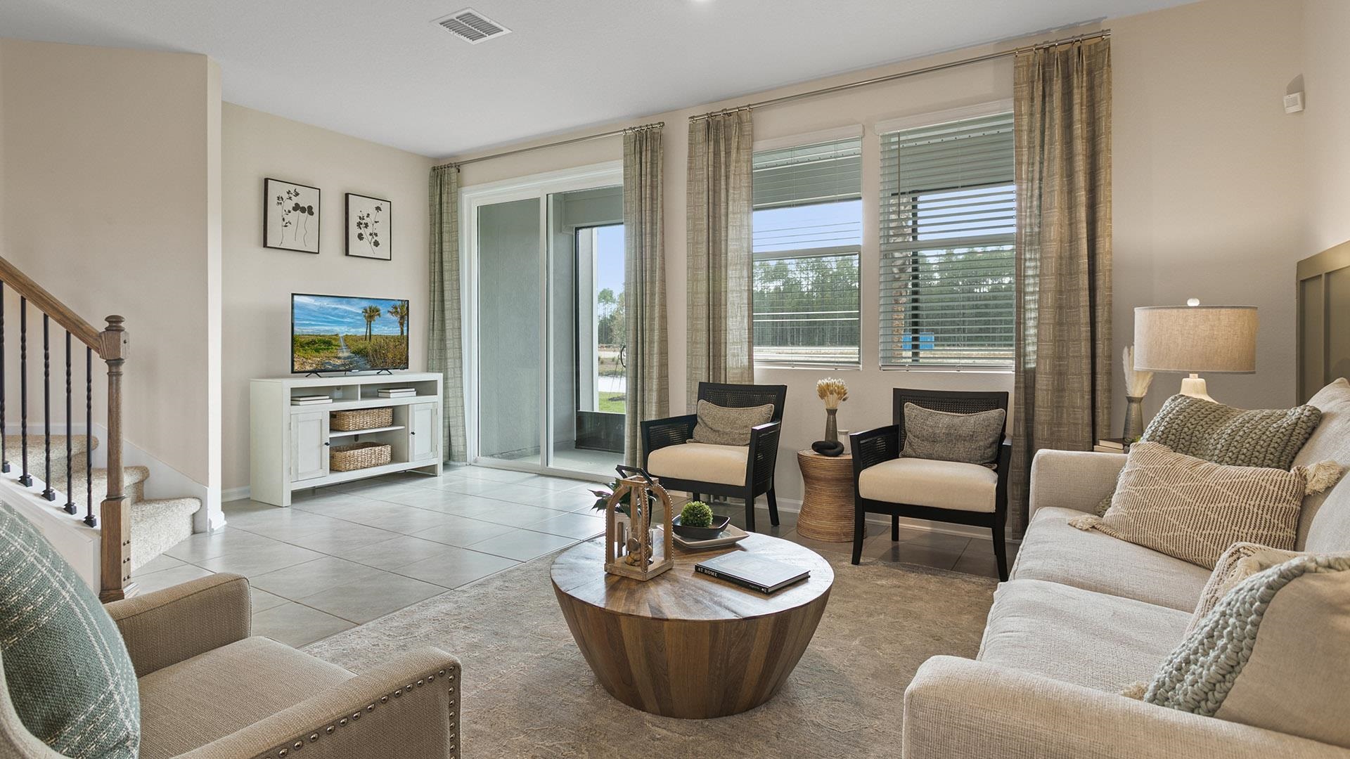155 Redbud Road Palm Coast, FL 32137 - Photo 14 of 39 a living room with furniture and a large window